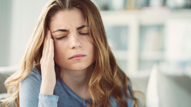 a woman having a migraine