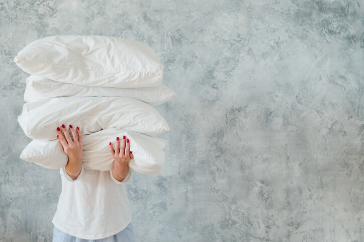 image of a woman holding sleep apnea pillows
