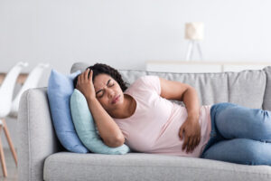 a woman experience symptoms of a stomach flu
